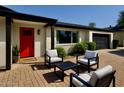 Inviting front porch with comfortable seating, a modern color scheme, and a well manicured landscape at 3109 E Cholla St, Phoenix, AZ 85028