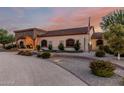 Charming exterior showcasing manicured landscaping and an arched entrance, adding to the home's curb appeal at 3718 N Briere Ct, Buckeye, AZ 85396