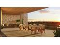 Relaxing covered balcony featuring outdoor dining and seating with stunning sunset and mountain views at 4849 N Camelback Ridge Rd # B308, Scottsdale, AZ 85251