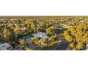 Expansive aerial view of lushly landscaped property with pool and neighboring homes at 4856 E Cheryl Dr, Paradise Valley, AZ 85253