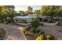 Stunning desert home featuring lush landscaping and a circular driveway at 4856 E Cheryl Dr, Paradise Valley, AZ 85253