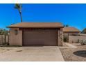 Single Gathering home showcasing a two-car garage and a well-maintained brick exterior at 5101 W Purdue Ave, Glendale, AZ 85302