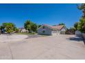 Spacious property featuring a large driveway and a three-car garage at 5127 W Dobbins Rd, Laveen, AZ 85339