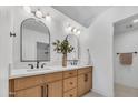 Modern bathroom with a double sink vanity, elegant mirrors, and contemporary fixtures at 6233 E Pinchot Ave, Scottsdale, AZ 85251