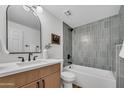 Well-lit bathroom boasting a modern vanity, stylish mirror, and a shower-tub combination with decorative tiling at 6233 E Pinchot Ave, Scottsdale, AZ 85251