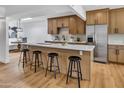 Stylish kitchen features stainless steel appliances, quartz countertops, and a kitchen island with seating at 6233 E Pinchot Ave, Scottsdale, AZ 85251