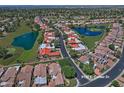Aerial view of a residential neighborhood, featuring houses, streets, and community golf course and lakes at 8120 E Cortez Dr, Scottsdale, AZ 85260