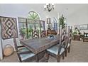 Dining room featuring a large wood table, unique chairs, and large arched windows with natural light at 8120 E Cortez Dr, Scottsdale, AZ 85260