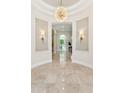 Elegant foyer with marble flooring, decorative sconces, and an ornate chandelier at 8216 E Angel Spirit Dr, Scottsdale, AZ 85255