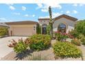 Charming single-story home showcasing desert landscaping, a two-car garage and elegant architectural details at 8216 E Angel Spirit Dr, Scottsdale, AZ 85255