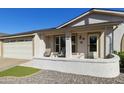 Inviting front exterior with a cozy porch, well-kept landscaping, and attached two-car garage at 922 S Ember Cir, Mesa, AZ 85208