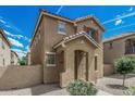Charming two-story home featuring a covered entryway and well-maintained desert landscaping at 923 E Agua Fria Ln, Avondale, AZ 85323
