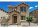 Charming two-story home featuring a covered entryway and well-maintained desert landscaping at 923 E Agua Fria Ln, Avondale, AZ 85323