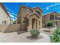 Charming two-story home featuring a covered entryway and well-maintained desert landscaping at 923 E Agua Fria Ln, Avondale, AZ 85323