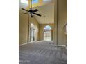 Bright living room features high ceilings, large windows, and plush carpeting at 1010 N Osprey Ct, Gilbert, AZ 85234
