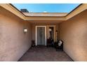 Inviting entryway with brick pavers, seating, and charming decor at 10211 W Hazelwood Ave, Phoenix, AZ 85037