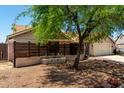 Charming single-story home featuring a private, gated courtyard with decorative fence at 10211 W Hazelwood Ave, Phoenix, AZ 85037