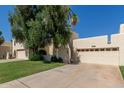 Lovely home with a two-car garage, mature landscaping, and well-maintained front yard at 1036 N Sierra Hermosa Dr, Litchfield Park, AZ 85340