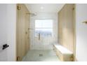 Walk-in shower featuring a glass enclosure, unique tile, and a built-in bench seat at 1102 W Peoria Ave # 17, Phoenix, AZ 85029
