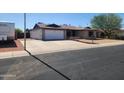 Attractive one-story house with a clean facade, spacious driveway and an attached garage at 11216 N 52Nd Ave, Glendale, AZ 85304