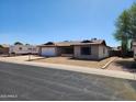 Lovely single-story home featuring a classic design, attached garage, and desert landscaping at 11216 N 52Nd Ave, Glendale, AZ 85304