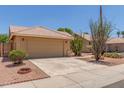 Single story home with 2 car garage, desert landscaping, and tiled roof at 1371 W Gary Dr, Chandler, AZ 85224