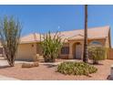 Single story home with desert landscaping, tiled roof, and a 2 car garage at 1371 W Gary Dr, Chandler, AZ 85224