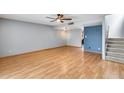 Bright living room with hardwood floors, fan, and a stairway leading to the upper level at 1822 W Marlette Ave, Phoenix, AZ 85015
