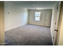 A carpeted bedroom featuring natural light from a large window at 1944 E Night Rider Rd, San Tan Valley, AZ 85140