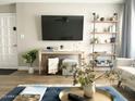 Inviting living room showcasing a large TV, decorative shelving, and comfortable seating at 2100 N Normal Ave, Tempe, AZ 85288