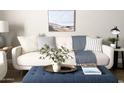 Comfortable living room with a tufted ottoman, plush cushions, and stylish decor at 2100 N Normal Ave, Tempe, AZ 85288