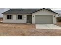 Inviting single-story home with a gray roof, a two-car garage and low maintenance landscaping at 22343 S Manzanilla Rd, Buckeye, AZ 85326