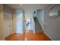 Spacious entryway with hardwood floors, a staircase, and access to the living areas at 2361 N 212Th Dr, Buckeye, AZ 85396