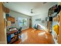 Bright office featuring hardwood floors, natural light, and space for a desk and chairs at 2361 N 212Th Dr, Buckeye, AZ 85396