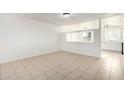 A bright living room featuring tile floors and a pass through to the kitchen at 2508 N 58Th Ln, Phoenix, AZ 85035