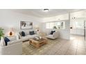 Bright and airy living room with neutral furniture, tile floors, and open access to the kitchen at 2508 N 58Th Ln, Phoenix, AZ 85035