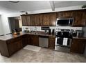 Well-equipped kitchen with stainless steel appliances, rich wood cabinetry, and granite countertops at 2726 W Butler Dr, Phoenix, AZ 85051
