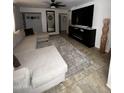 Spacious living room with tile flooring, a modern ceiling fan, and a comfortable sectional sofa at 2726 W Butler Dr, Phoenix, AZ 85051
