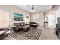 Spacious living room with plush leather furniture, a decorative rug, and ample natural light at 3041 E Fremont Rd, Phoenix, AZ 85042
