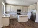 Bright, modern kitchen with white cabinets, stainless steel appliances and a kitchen island at 33220 N 60Th Way, Scottsdale, AZ 85266