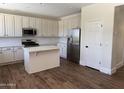 Modern kitchen featuring white cabinets, stainless steel appliances, white backsplash, and a kitchen island at 33220 N 60Th Way, Scottsdale, AZ 85266