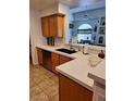 Kitchen features stainless appliances, wood cabinets, and views into the adjacent living area at 4202 E Broadway Rd # 223, Mesa, AZ 85206