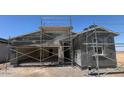 New construction exterior of a single Gathering home with stucco and scaffolding at 47706 W Kenner Dr, Maricopa, AZ 85139