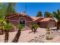Expansive single-story home boasts a desert-landscaped yard, a terracotta tile roof, and large arched front window at 5580 W Kesler St, Chandler, AZ 85226