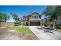 Beautiful two-story home featuring a lush green lawn and a long driveway at 7274 W State Ave, Glendale, AZ 85303