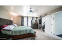 Cozy main bedroom with a comfortable bed, dresser, and closet space at 7274 W State Ave, Glendale, AZ 85303