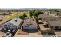 Aerial view of a single-Gathering home featuring solar panels, desert landscaping, and two-car garage at 8668 N 107Th Dr, Peoria, AZ 85345
