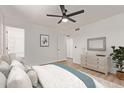 Inviting bedroom featuring a ceiling fan, dresser, and soothing decor for relaxation at 934 E Wahalla Ln, Phoenix, AZ 85024