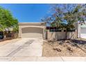 Detached garage with a neutral facade and a concrete driveway surrounded by desert landscaping at 934 E Wahalla Ln, Phoenix, AZ 85024