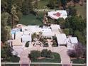 Expansive estate showcasing lush landscaping, a sparkling pool, and a circular driveway. Guest house included at 94 Biltmore Estates Dr, Phoenix, AZ 85016